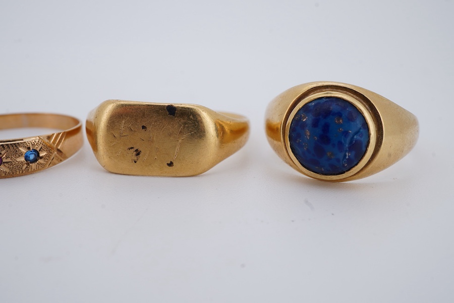 Five gold rings, comprising: an 18ct gold and turquoise ring, British hallmarks; a paste eternity ring; a synthetic sapphire and synthetic ruby ring; and a signet ring, faintly engraved, combined gross weight approximate
